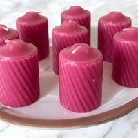 Box Scented Plum Votive Candles.